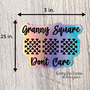 May include: A holographic sticker with the text "Granny Square Don't Care" and a pattern of three granny squares. The sticker is 3 inches wide and 2.25 inches tall. The sticker is from Green Fox Farms Designs.