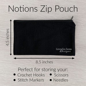 May include: Black zippered pouch with the text "Green Fox Farms Designs" printed on the front. The pouch measures 8.5 inches by 4.5 inches and is perfect for storing crochet hooks, scissors, stitch markers, and needles.