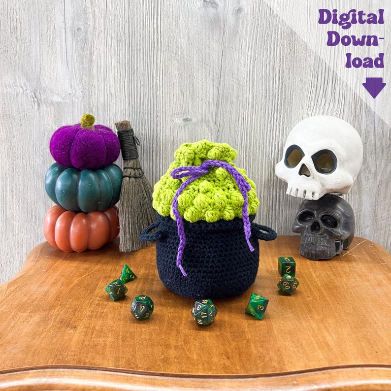 May include: A black crochet cauldron-shaped bag with a lime green top and purple drawstring. The image includes decorative pumpkins, dice, a broom, and two skull figurines. Text in the image reads "Digital Download".
