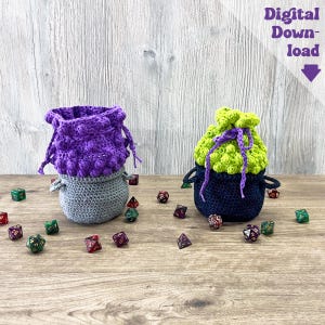 May include: Two handmade crochet dice bags in purple, gray, and green, with a scattering of colorful dice on a wooden surface. One bag is purple and gray, the other is green and navy blue. The text "Digital Download" is visible.