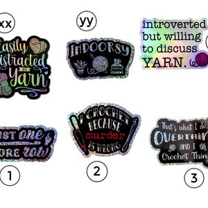 May include: Ten holographic stickers with various sayings about yarn and crocheting. The stickers are black with rainbow holographic glitter. The sayings include "Easily Distracted by Yarn", "Indoorsy", "Introverted but willing to discuss yarn", "Just one more row", "I crochet because murder is wrong", and "That's what I do, I overthink and I crochet things".