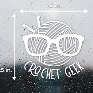 May include: White vinyl sticker of a yarn ball wearing glasses with the text "CROCHET GEEK" underneath. The sticker is 4.5 inches wide and 4.5 inches tall.