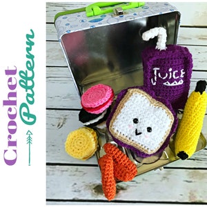May include: A crocheted lunchbox set with a sandwich, juice box, banana, cookies, and french fries. The lunchbox is a metal tin with a green handle. The crocheted items are all in different colors and have a cute, cartoonish style.