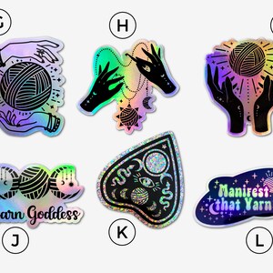 May include: A set of 10 holographic stickers featuring a variety of designs related to yarn and witchcraft. The stickers feature images of hands holding yarn, a yarn ball, a crescent moon, a pentagram, and the text "Yarn Goddess" and "Manifest That Yarn".