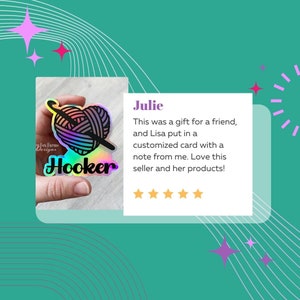 May include: A holographic sticker featuring a yarn ball and crochet hook, with the text "Hooker" in rainbow lettering. The sticker is held in a hand. The text "Jesigns" is visible in the background. The sticker was a gift for a friend, and the seller included a personalised card with a note. The seller received a five-star review from a customer named Julie.