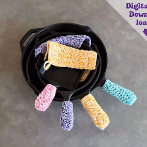 May include: A stack of black cast iron skillets featuring colorful, textured, crocheted handle covers in shades of pink, purple, yellow, and teal. The image includes the text Digital Download with a downward pointing arrow in the top right corner.