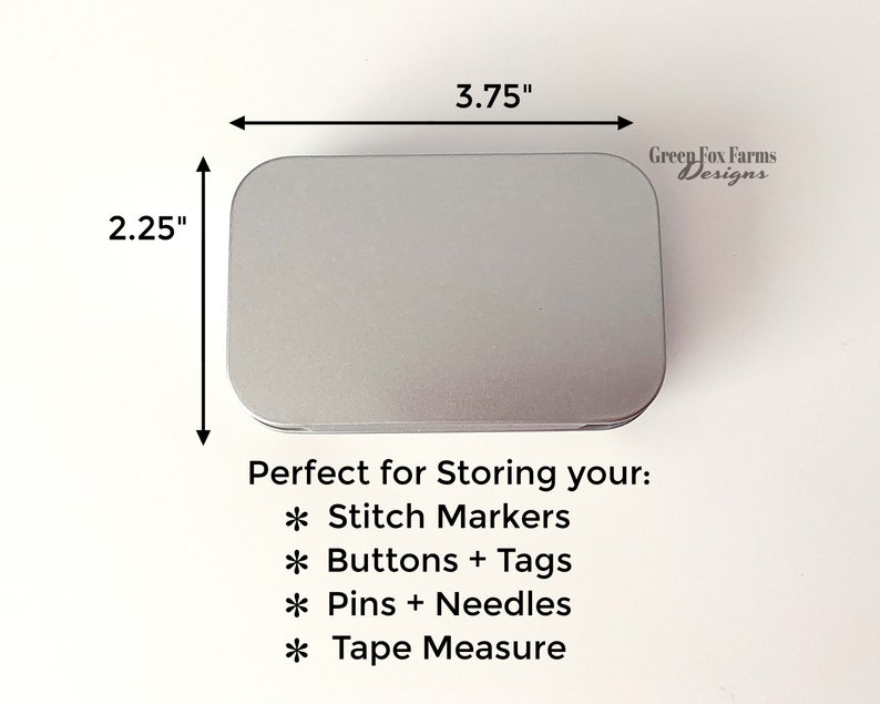 May include: A silver metal tin with rounded edges, measuring 3.75 inches by 2.25 inches. The tin is labeled "Green Fox Farms Designs" and is perfect for storing small items like stitch markers, buttons, tags, pins, needles, and tape measures.