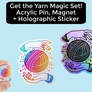 May include: A set of three yarn magic themed items: a holographic sticker, a magnet, and an acrylic pin. Each item features a pair of hands holding a ball of yarn with a rainbow gradient and a black outline. The text "Get the Yarn Magic Set! Acrylic Pin, Magnet + Holographic Sticker" is at the top of the image.