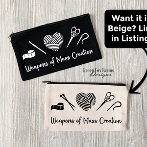 May include: Two zippered pouches with the text "Weapons of Mass Creation" and images of yarn, scissors, and needles. The pouch on the left is black and the pouch on the right is beige.