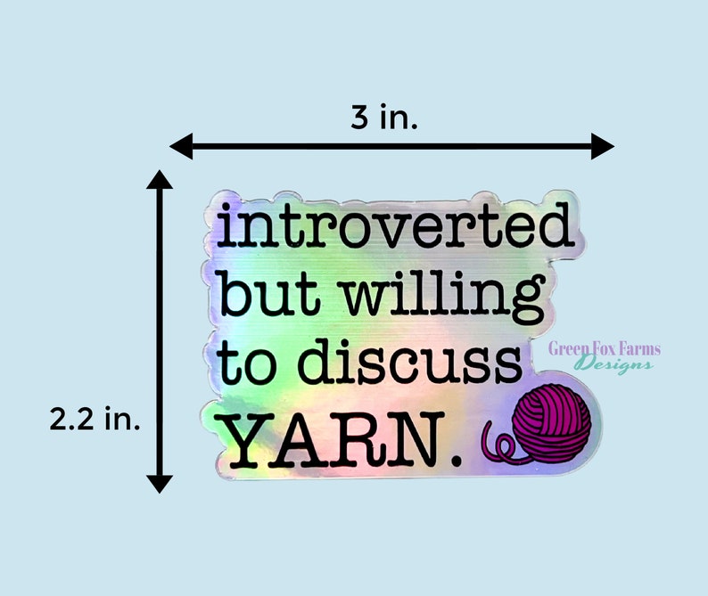 May include: A holographic sticker with the text "introverted but willing to discuss YARN." and a pink yarn ball. The sticker is 3 inches wide and 2.2 inches tall.
