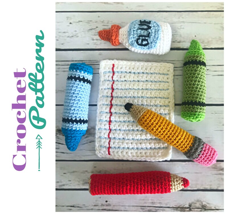 May include: A set of crocheted school supplies including a blue crayon, a green crayon, a yellow pencil, a red pencil, a white notepad with red lines, and a bottle of glue.