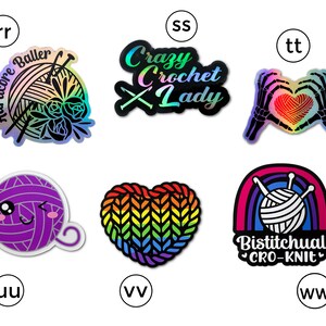 May include: Nine iridescent vinyl stickers with different designs related to crocheting and knitting. The stickers feature a rainbow heart, a rainbow yarn ball, a yarn ball with a face, a rainbow heart with yarn, a rainbow yarn ball with a rainbow, a yarn ball with needles, a yarn ball with flowers, a skeleton hand holding a yarn heart, and a text that says "Crazy Crochet Lady".