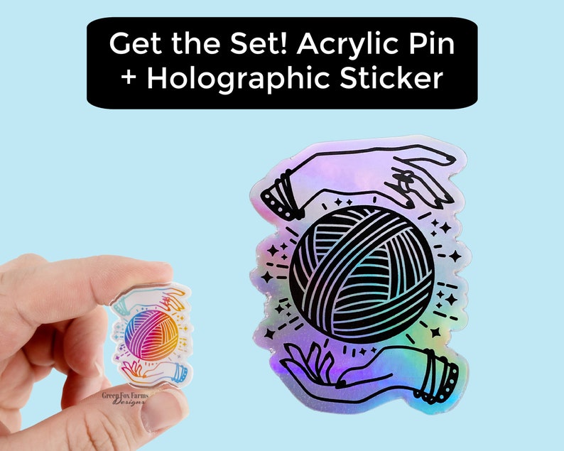 May include: A holographic sticker featuring a pair of hands holding a ball of yarn. The sticker has a rainbow iridescent finish. The text "Get the Set! Acrylic Pin + Holographic Sticker" is displayed above the sticker.