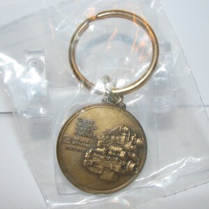 John Deere 3 Million Diesel Engines Manufactured 1949-1990 Brass Keychain Fob Dubuque, Waterloo Iowa and Saran France jd Collectible