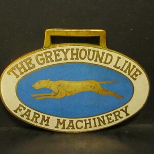 The Greyhound Line Farm Machinery Pocket Watch Fob of Month 7 Banting Mfg Toledo Advertising Promo Giveaway Brass & Enamel