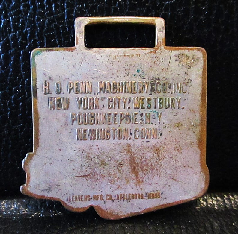May include: A brass key chain with the text "H.O. PENN, MACHINERY CO. INC. NEW YORK CITY: WESTBURY. POUGHKEEPSIE, N.Y. NEWINGTON, CONN. LEAVENS MFG. CO. ATLEBORO, MASS."
