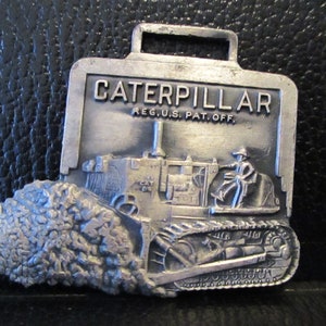 Caterpillar Cat D9 Crawler Tractor Dozer Bulldozer Metal Pocket Watch Fob Advertising Promo Perkins Machinery Company  Leavens Manufacturing