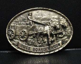 Tony Lama Collection BUCK BOARD Wagon Wheel Series Belt Buckle FIRST Edition Solid Brass Limited Edition S/N 778 Horses Pioneer Silver Color