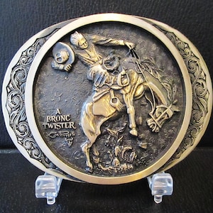 A Bronc Twister by C.M. Russell Artist Westerner Collection Solid Brass Belt Buckle Limited Edition Manufacturer ADM Award Design Medals