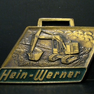 Hein Werner Corporation Waukesha WI Crawlers Carriers Hydraulic Excavators & Cranes Brass Pocket Watch Fob Construction Advertising Promo