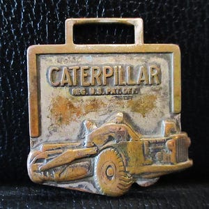 Caterpillar Cat DW21 Scraper Tractor Earth Mover Brass Pocket Watch Fob Advertising Promo H O Penn Machinery Company NY CT  Leavens Mfg