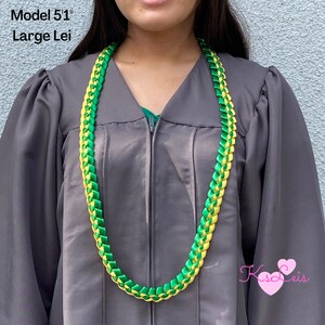 May include: A large lei, approximately 51 inches long, in a vibrant combination of green and yellow. The lei is made of woven ribbons, creating a braided pattern. The text "Model 51" and "Large Lei" is visible in the image.
