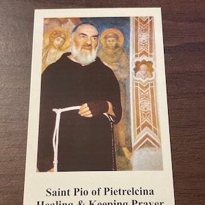 May include: A vintage-style prayer card featuring a painting of Saint Pio of Pietrelcina. The card has a white background with black text that reads "Saint Pio of Pietrelcina Healing & Keeping Prayer".
