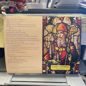 May include: A stained glass image of Saint Patrick, a Christian saint and patron saint of Ireland. The image is set against a background of a church window. The text below the image reads "Saint Patrick Pray for us."