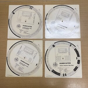 May include: Four white circular charts with black text and graphics. Each chart is labeled "RUBRICATOR" and includes a different title: "Pontifical Solemn Mass of the Throne", "Solemn High Mass", "Pontifical Solemn Mass of the Throne", and "Solemn Requiem High Mass".
