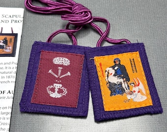 May include: Two purple fabric squares with embroidered images. The left square has a white image of a chalice with three nails above it. The right square has a yellow background with a white image of a man in a black robe holding a white cross. The squares are connected by a purple cord.