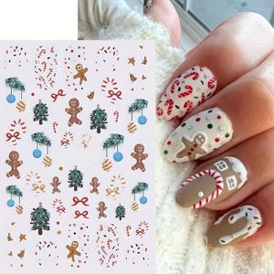 May include: A sheet of Christmas nail stickers featuring a range of designs, including candy canes, gingerbread men, Christmas trees, and baubles. The stickers are on a white background.