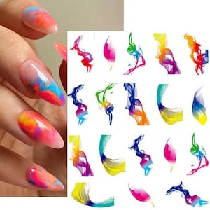 May include: A hand with long, oval-shaped nails painted with vibrant, swirling colors of pink, orange, blue, and yellow. Beside the hand are various colorful abstract nail art designs in shades of red, pink, blue, green, yellow, and purple.