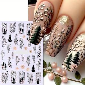 May include: Nail art stickers with a forest theme. The stickers feature small trees, branches, and flowers in black, brown, and green.