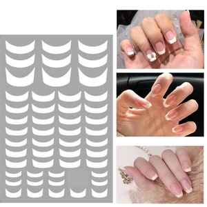 May include: A sheet of white nail stickers with a curved shape. The stickers are designed to create a French manicure look. The sheet contains 40 stickers.