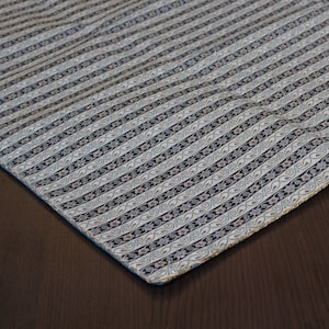 May include: A blue and white patterned fabric with a silver trim. The fabric has a subtle sheen and a delicate floral design.