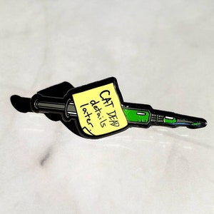 The ReAnimator Movie enamel pin, approximately 1 inch long