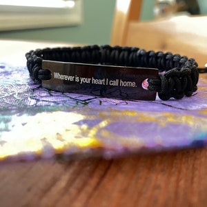 Brandi Carlile (singer/songwriter ) bracelet, in black, with a favored lyric: “Wherever is your heart, I call home.””