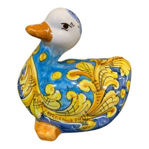 Sicilian ceramic duck with baroque decoration on a blue background - Measurements 20x13x16 cm