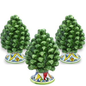 May include: Three ceramic pine cone sculptures with green painted pine cones and colorful, patterned bases.