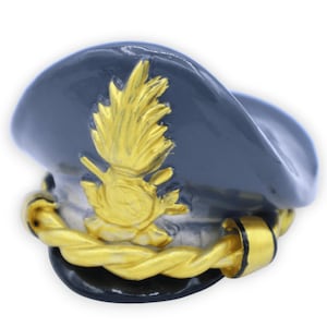 May include: A gray military-style hat with a gold braid trim and a gold emblem featuring a stylized flame design.