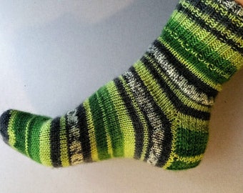May include: Green, black, and white striped knitted sock.