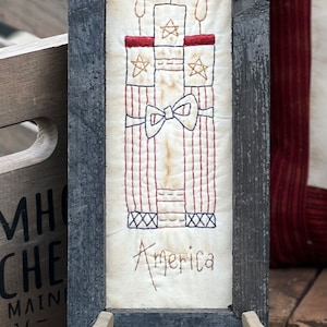 Broderie encadrée primitif pétard Americana