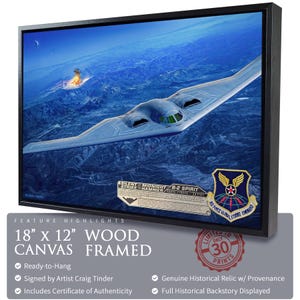 May include: Framed wood canvas art print featuring a B-2 Spirit stealth bomber flying over a landscape. The artwork is 18" x 12" and includes the text "SILENT MIDNIGHT STRIKE HAMMER B-2 SPIRIT". The print is signed by artist Craig Tinder.