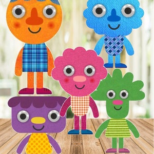 May include: Five colourful felt characters with googly eyes. The characters are a blue, green, pink, purple, and orange. Each character has a different patterned outfit and a smiling face.
