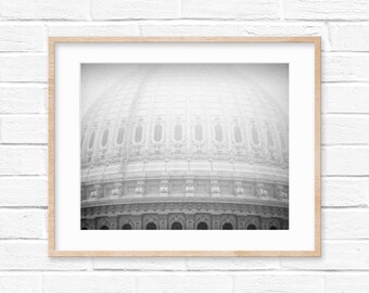 May include: A black and white photograph of a large, ornate dome with intricate details. The dome is partially obscured by fog or mist, creating a soft, ethereal effect.