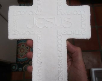 Plastic cross wall art with inspirational words.