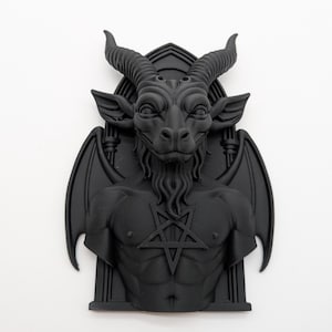 May include: A black sculpture of Baphomet, a goat-headed figure with horns, wings, and a pentagram on its chest. The sculpture has a detailed, textured surface and is set against a white background. The figure has a long beard and is in a gothic style.