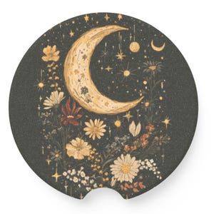 May include: Round car coaster with a celestial design. A crescent moon is surrounded by stars and floral elements in shades of gold, white, and red against a dark background. The coaster has a small notch for easy removal.