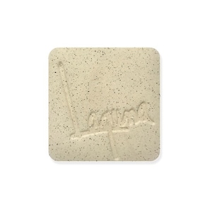 May include: A close-up of a light beige tile with a speckled texture. The tile has the word "Lama" embossed on it.