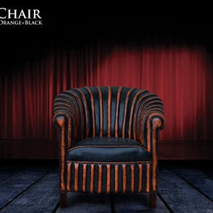 May include: A black and orange striped armchair with a tufted back and seat. The chair is on a wooden floor in front of a red curtain.
